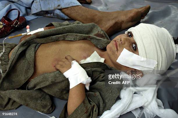 An injured Pakistani boy lies on a hospital bed following a suicide car bomb blast in Peshawar on October 9, 2009. A massive suicide car bomb on...