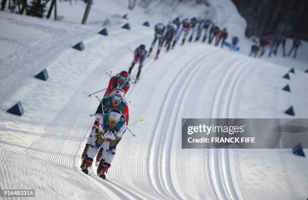 Sweden's Charlotte Kalla leads the pack during the women's 7.5km + 7.5km cross-country skiathlon at the Alpensia cross country ski centre during the...