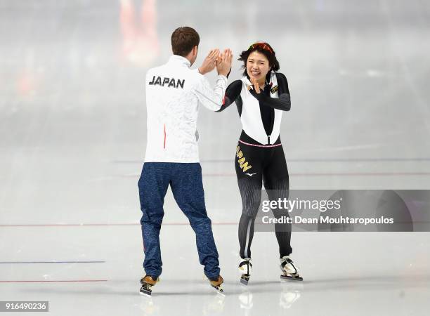 Ayano Sato of Japan celebrates with her coach after victory over Luiza Zlotkowska of Poland during the Women's Speed Skating 3000m on day one of the...