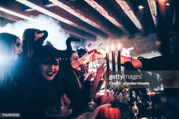 barman giving cocktail to woman at halloween party - halloween party imagens e fotografias de stock