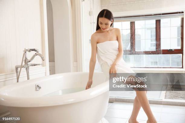 young women in the bathroom - sunken bath stock pictures, royalty-free photos & images