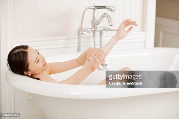 young women in the bathroom - sunken bath stock pictures, royalty-free photos & images
