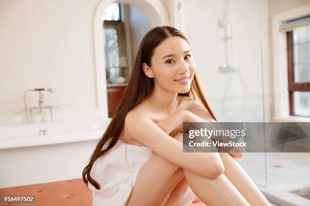 a fashionable young woman in the bathroom - sunken bath stock pictures, royalty-free photos & images