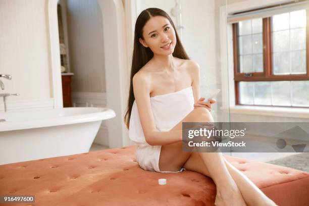 a fashionable young woman in the bathroom - sunken bath stock pictures, royalty-free photos & images