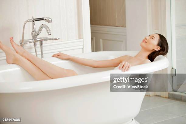 young women in the bathroom - sunken bath stock pictures, royalty-free photos & images