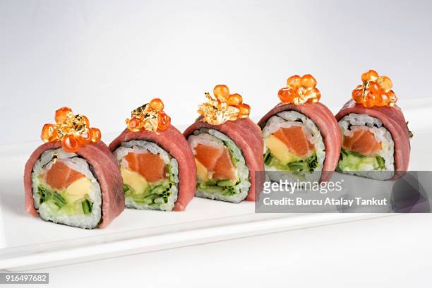 luxury sushi rolls with gold leaves - maki sushi stockfoto's en -beelden