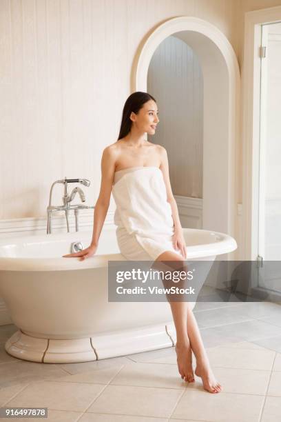 young women in the bathroom - sunken bath stock pictures, royalty-free photos & images