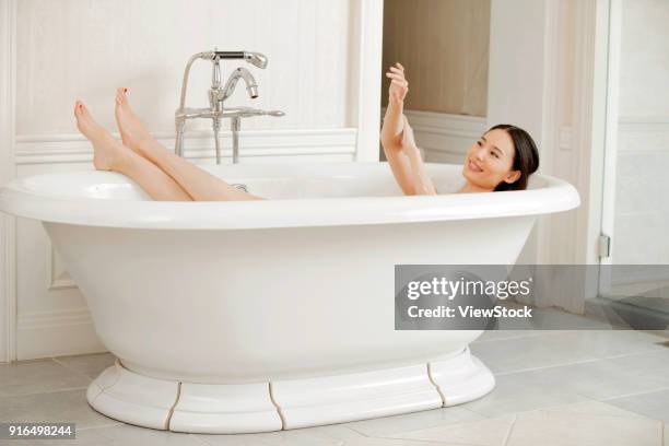 young women in the bathroom - sunken bath stock pictures, royalty-free photos & images