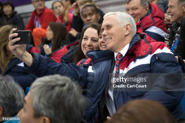 United States Vice President Mike Pence takes a selfie photograph with his wife wife Karen and retired U.S figure skater Sarah Hughes as they arrive...