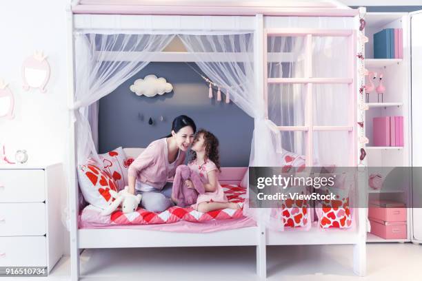 cute little girl and her mother play in the bedroom - seize the day bed private view stock pictures, royalty-free photos & images