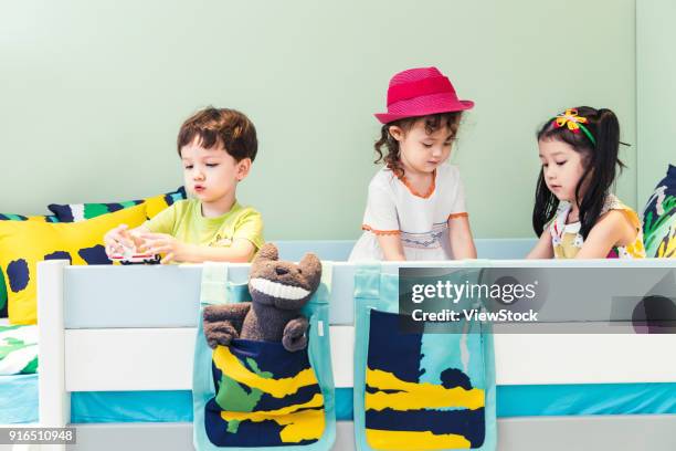 children play on the bed - bunk beds for 3 ストックフォトと画像