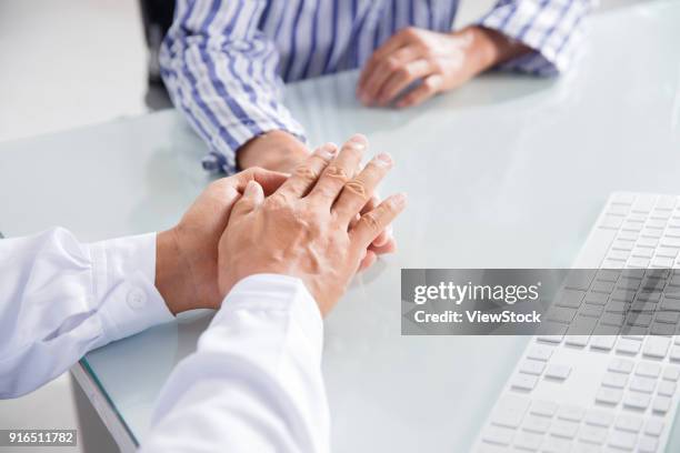 the doctors hand holding the patients - ____ stock pictures, royalty-free photos & images