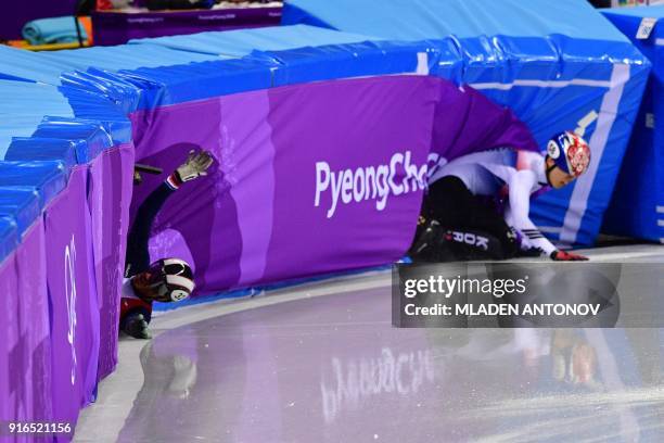 France's Thibaut Fauconnet and South Korea's Hwang Daeheon crash in the men's 1,500m short track speed skating A final event during the Pyeongchang...