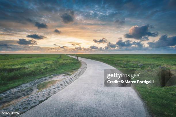 footpath to the sunset - wattenmeer national park stock pictures, royalty-free photos & images