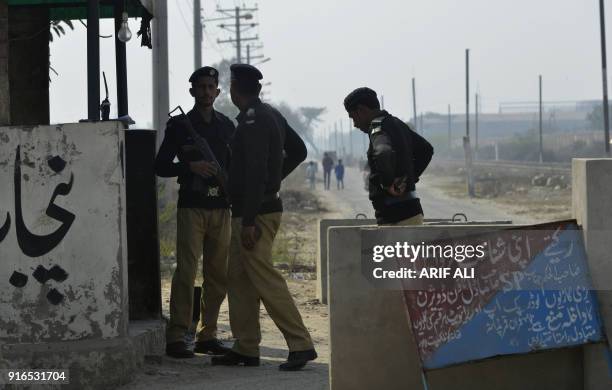 Pakistani policemen stand guard outside the check pint of Kot Lakhpat Jail where Mohammad Imran, the suspect accused of raping and murdering a young...