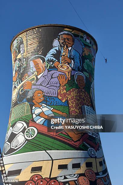 Man performs a bungee jump from the top of a thermal power planted, closed 11 years ago, in Soweto on June 28, 2009. The cooling tower is about 100m...