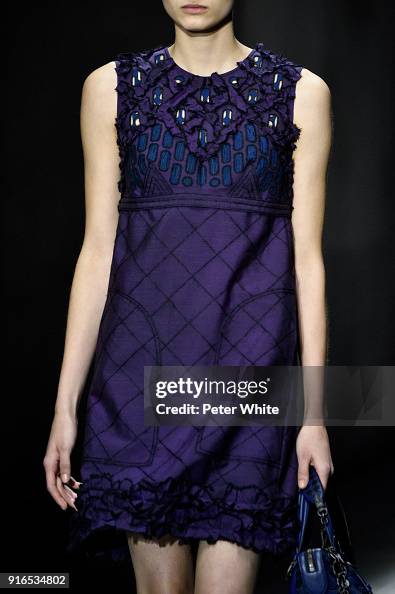 A model, fashion detail, walks the runway at Bottega Veneta
