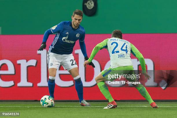 Marko Pjaca of Schalke and Sebastian Jung of Wolfsburg battle for the ball during the DFB Cup match between FC Schalke 04 and VfL Wolfsburg at...