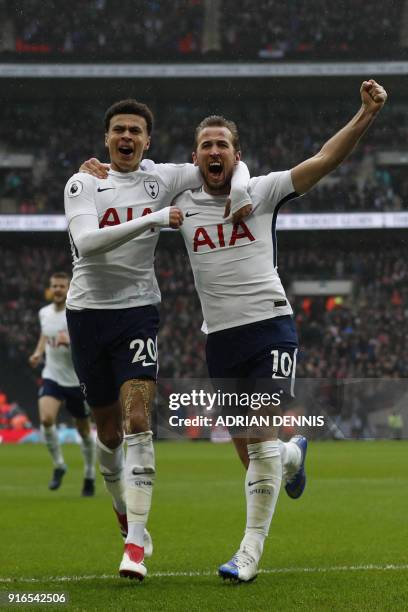 Tottenham Hotspur's English striker Harry Kane celebrates scoring the opening goal with Tottenham Hotspur's English midfielder Dele Alli during the...