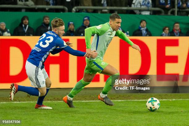 Cedric Teuchert of Schalke and Jeffrey Bruma of Wolfsburg battle for the ball during the DFB Cup match between FC Schalke 04 and VfL Wolfsburg at...