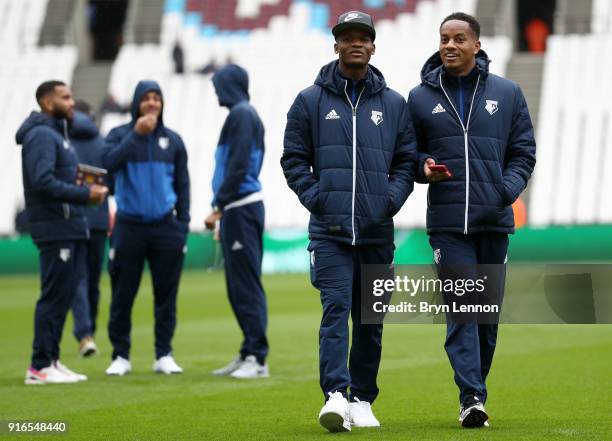 Andre Carrilo of Watford speaks to Didier Ndong of Watford on the pitch prior to the Premier League match between West Ham United and Watford at...