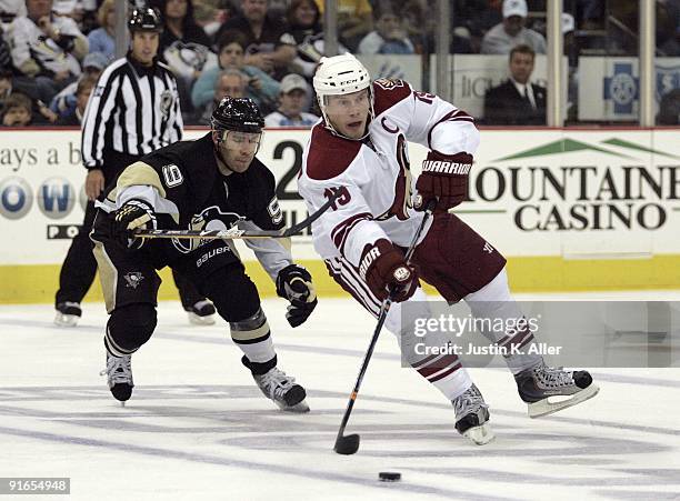 Shane Doan of the Phoenix Coyotes makes a pass as Pascal Dupuis of the Pittsburgh Penguins stick checks at Mellon Arena on October 07, 2009 in...