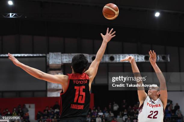 Nick Fazekas of the Kawasaki Brave Thunders shoots while under pressure from Joji Takeuchi of the Alvark Tokyo during the B.League match between...