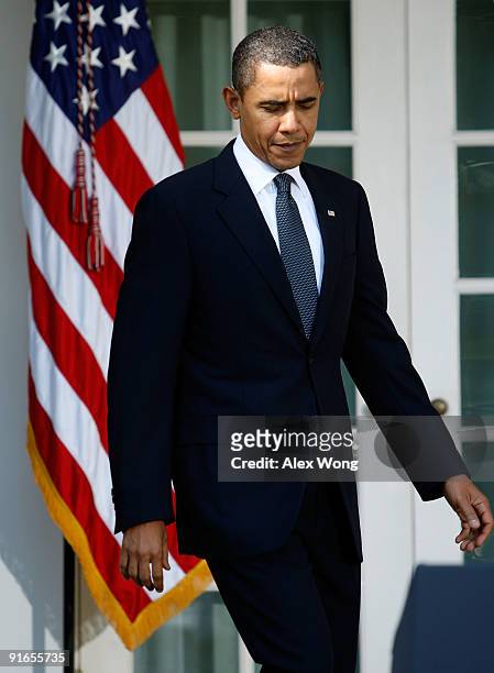President Barack Obama walks toward the podium prior to speaking from the Rose Garden of the White House after winning the Nobel Peace Prize October...