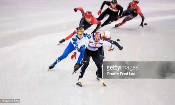 Hyojun Lim of Korea leads Sjinkie Knegt of the Netherlands and Charles Hamelin of Canada during the Men's 1500m Short Track Speed Skating final on...