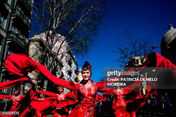 Revelers perform during celebrations for the Chinese New Year parade, marking the year of the Dog, in Lisbon on February 10, 2018. / AFP PHOTO /...