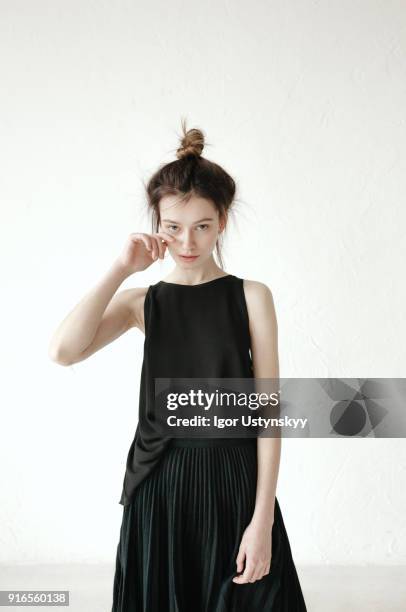studio shot of crying young woman against white background - studio shot lonely woman stock-fotos und bilder