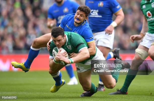Robbie Henshaw of Ireland is tackled by Marcello Violi of Italy during the NatWest Six Nations match between Ireland and Italy at Aviva Stadium on...