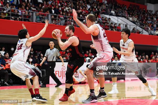 Zack Baranski of the Alvark Tokyo handles the ball under pressure from the Kawasaki Brave Thunders defense during the B.League match between Alverk...