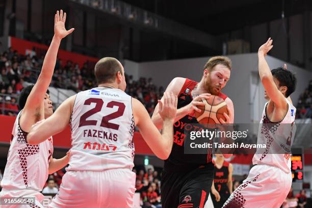 Alex Kirk of the Alvark Tokyo handles the ball under pressure from the Kawasaki Brave Thunders defense during the B.League match between Alverk Tokyo...