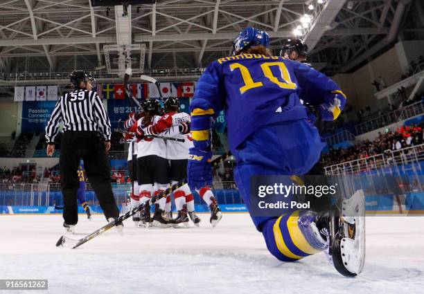 Emilia Ramboldt, of Sweden, watches as Japanese players celebrates a goal during the second period during the Women's Ice Hockey Preliminary Round -...