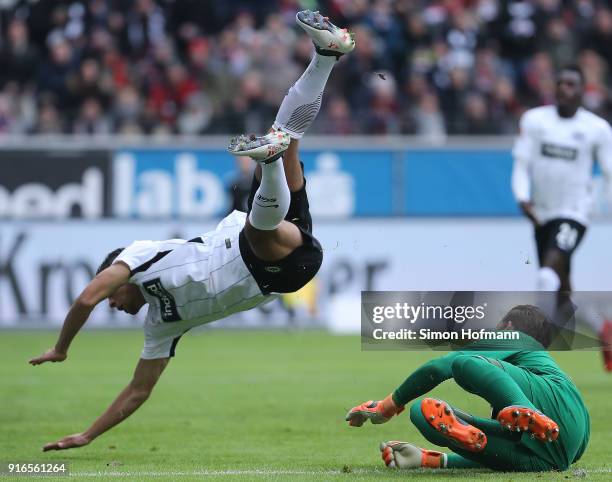 Timothy Chandler of Frankfurt lifts off after colliding with goalkeeper Timo Horn of Koeln during the Bundesliga match between Eintracht Frankfurt...