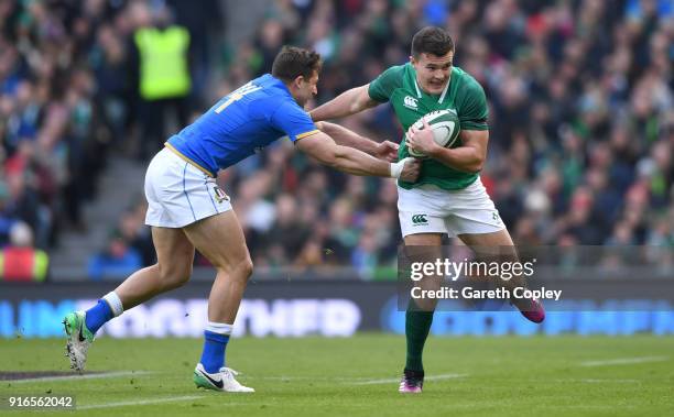 Jacob Stockdale of Ireland gets past Tommaso Benvenuti of Italy during the NatWest Six Nations match between Ireland and Italy at Aviva Stadium on...