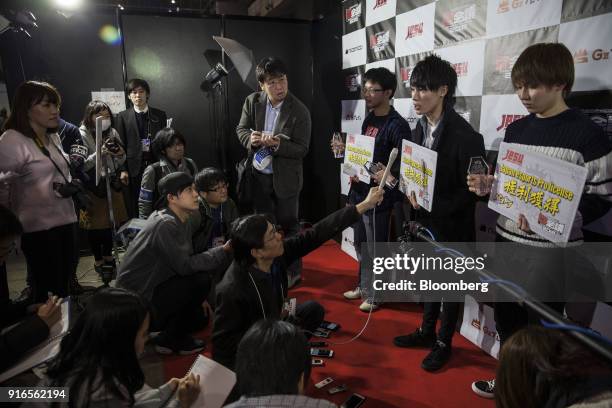 Aka Su, center, answers questions from members of the media along with other participants, after winning first place at GungHo Online Entertainment...