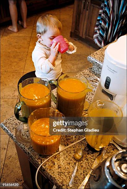 Two-year-old Angelina sips some freshly squeezed orange juice made for Sunday brunch. She is one of 21 children in a polygamist family consisting of...