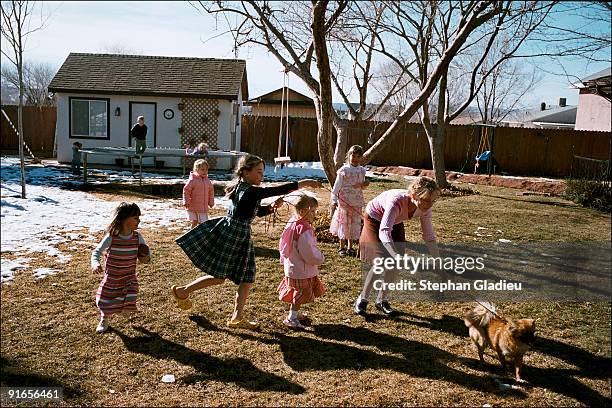 Some of Ray Timpson's children playing in the garden of the house they share with their very large family consisting of one father, six mothers and...