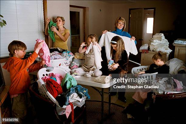 Valerie, one of three wives in a polygamist family living in the Salt Lake Valley, folds the laundry with the help of five children. This plural...
