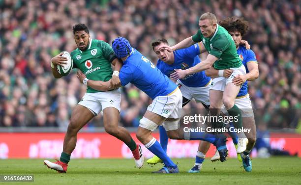 Bundee Aki of Ireland is tackled by Simone Ferrari of Italy during the NatWest Six Nations match between Ireland and Italy at Aviva Stadium on...