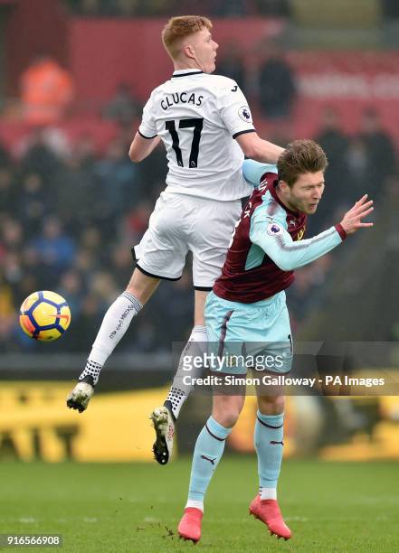 Swansea City's Sam Clucas and Burnley's Jeff Hendrick compete for a header during the Premier League match at the Liberty Stadium, Swansea.
