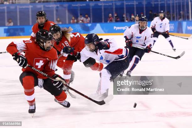 Jongah Park of Korea skates against Tess Allemann of Switzerland during the Women's Ice Hockey Preliminary Round - Group B game on day one of the...