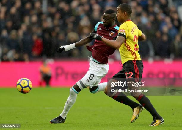 Cheikhou Kouyate of West Ham United and Marvin Zeegelaar of Watford battle for the ball during the Premier League match between West Ham United and...
