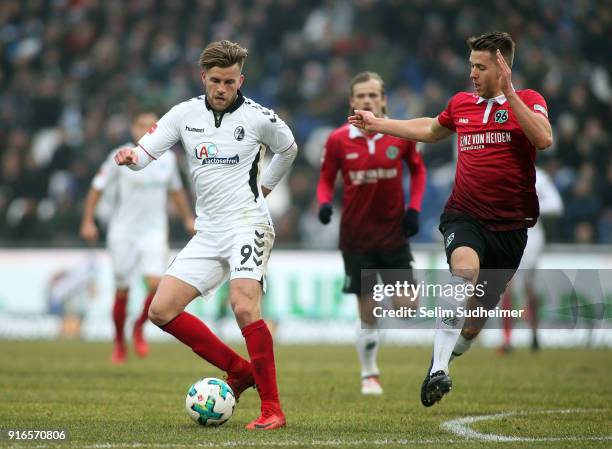 Lucas Hoeler of SC Freiburg fights for the ball with Waldemar Anton of Hannover 96 during the Bundesliga match between Hannover 96 and Sport-Club...