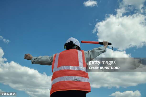 traffic guard holding traffic rod - verkeerspolitie stockfoto's en -beelden