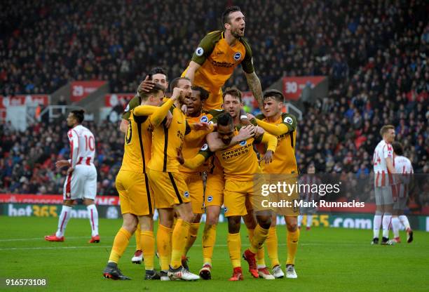 Jose Izquierdo of Brighton and Hove Albion celebrates with teammates after scoring his side's first goal during the Premier League match between...