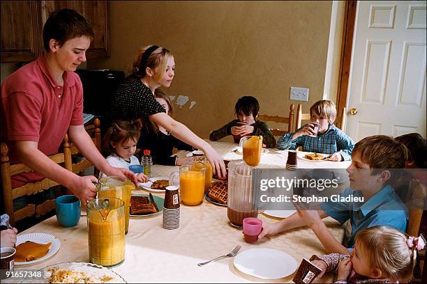 Sunday brunch in a polygamist family consisting of one husband , three wives , and 21 children. Sunday is one of the few days of the week when the...