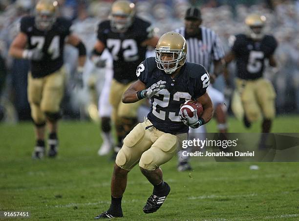 Golden Tate of the Notre Dame Fighting Irish runs against the Washington Huskies on his way to a 67 yard touchdown on October 3, 2009 at Notre Dame...